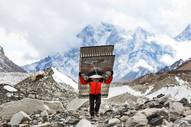 Sherpa carrying heavy load